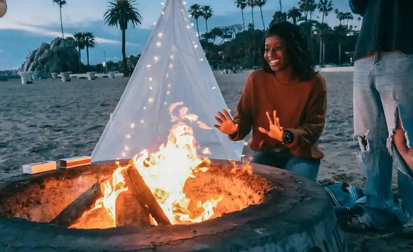 Maternal? Woman Instinctually Tends to Needs of Bonfire