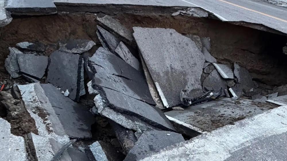 Watch: Road collapse in Omaha leaves vehicles stranded inside sinkhole
