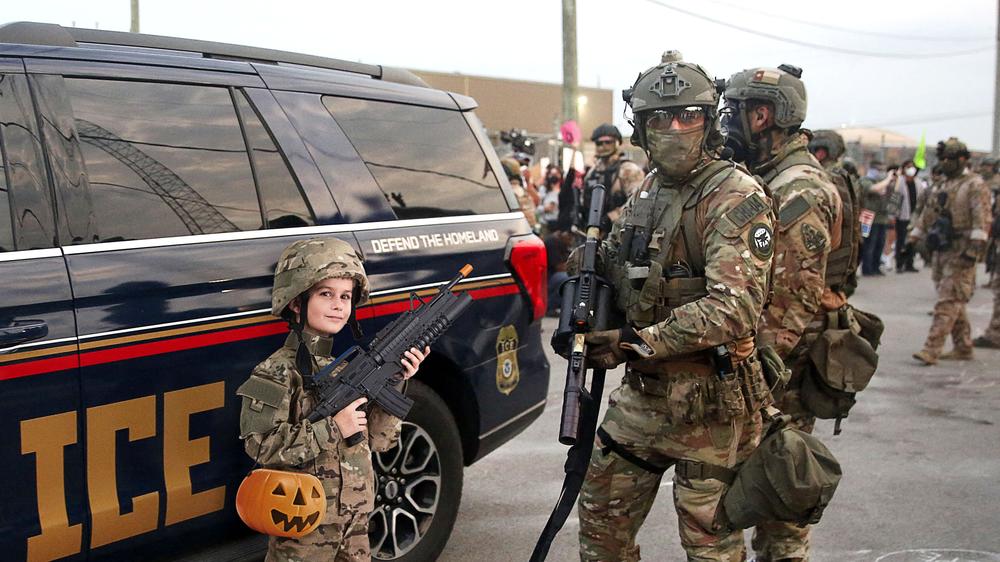 ICE Agent, 7-Year-Old Both Wearing Same ‘Military Commando’ Halloween Costume