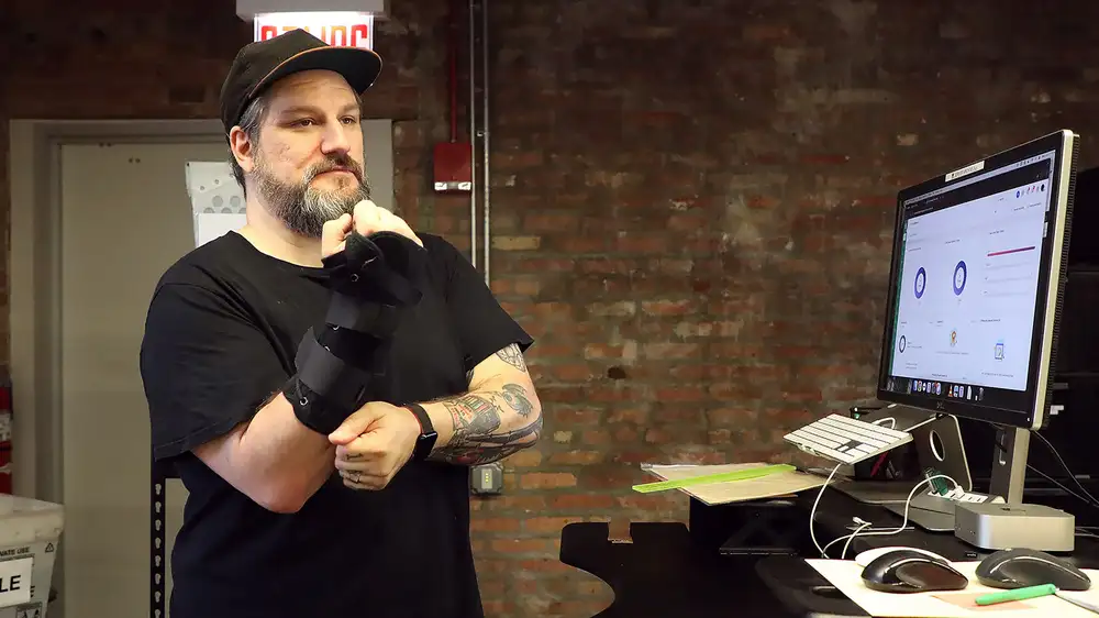 IT Guy Slips On Carpal Tunnel Braces With Calm Of Soldier Prepared To Die In Battle